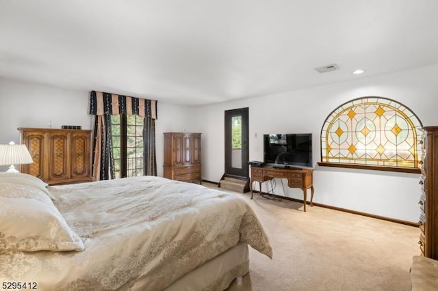 bedroom with light colored carpet and multiple windows