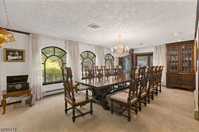 dining room featuring an inviting chandelier, light colored carpet, a baseboard radiator, and a textured ceiling