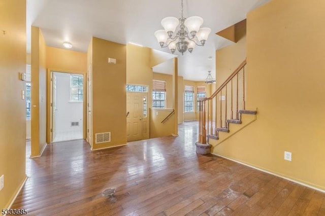 entryway featuring hardwood / wood-style flooring and an inviting chandelier