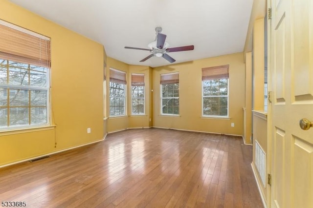 spare room featuring hardwood / wood-style floors and ceiling fan