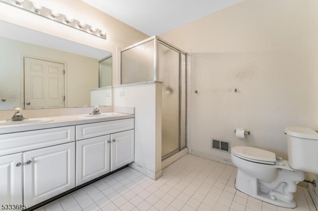 bathroom featuring vanity, toilet, walk in shower, and tile patterned floors