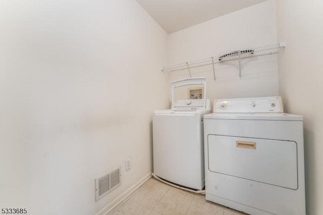 clothes washing area featuring washing machine and dryer