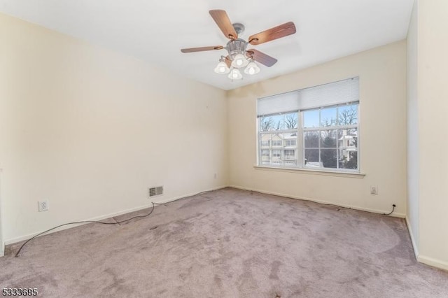 carpeted empty room featuring ceiling fan