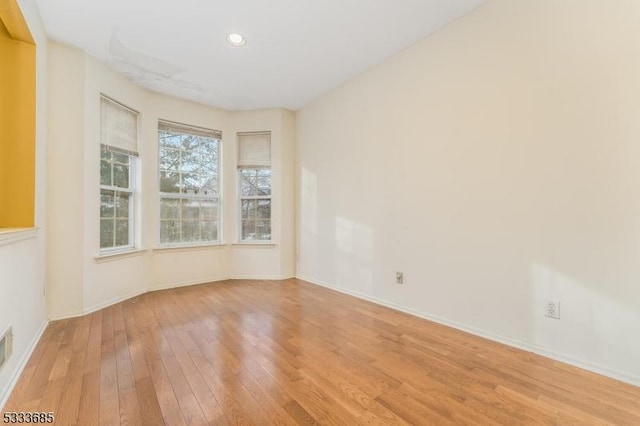 unfurnished room with light wood-type flooring