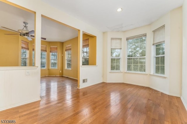 empty room with hardwood / wood-style flooring and ceiling fan