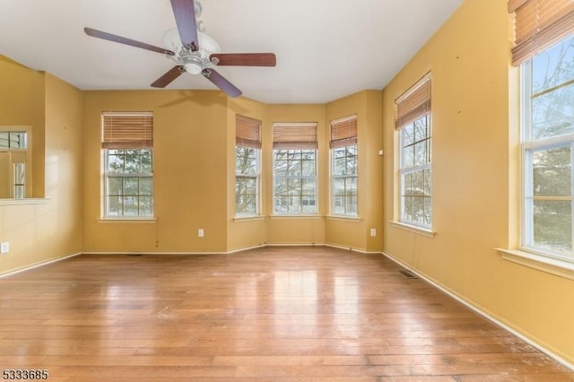 unfurnished room with light wood-type flooring and ceiling fan