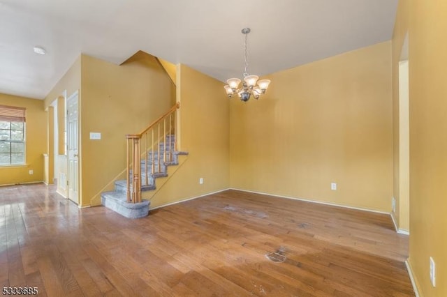 interior space featuring wood-type flooring and an inviting chandelier