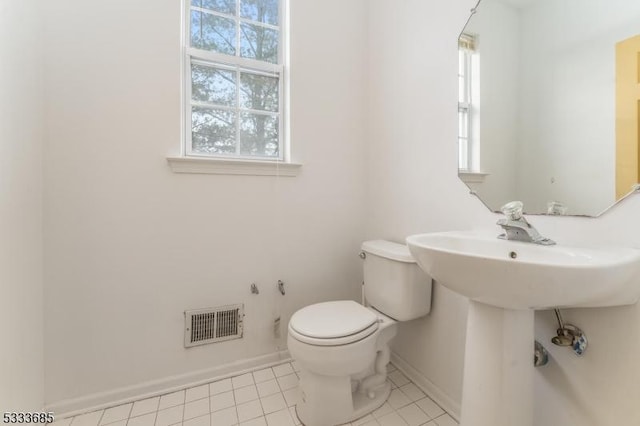 bathroom featuring toilet and tile patterned floors