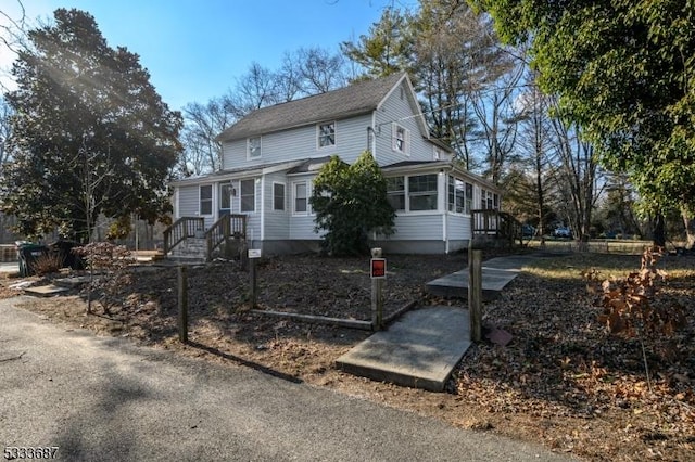 view of front of house featuring a sunroom