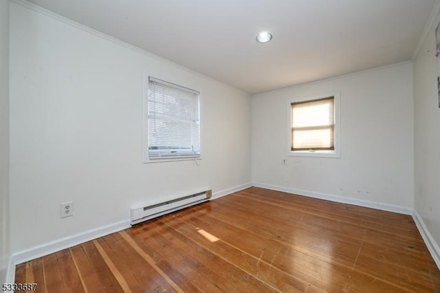 unfurnished room featuring ornamental molding, hardwood / wood-style floors, and baseboard heating