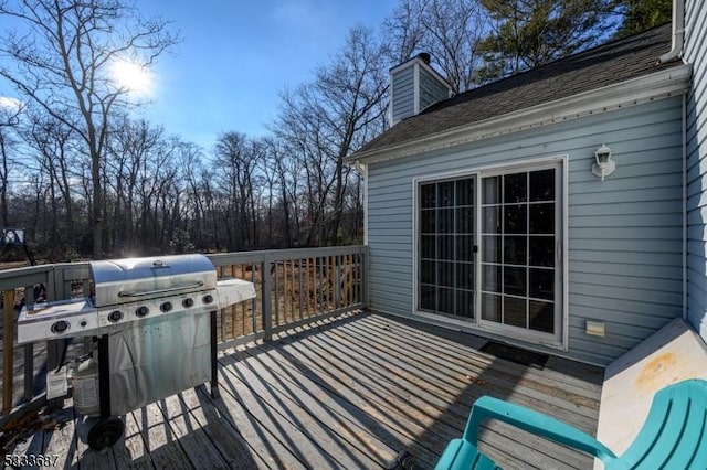 wooden deck featuring a grill