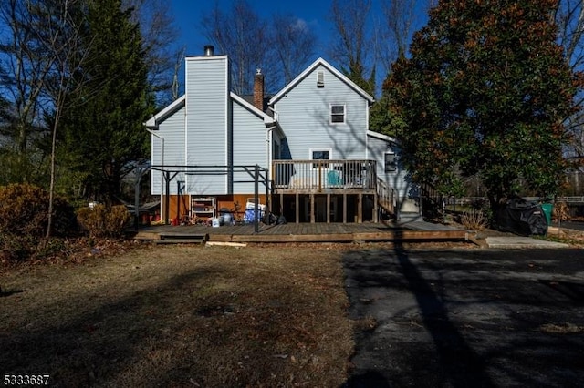 rear view of property featuring a deck