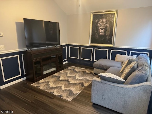 living room with lofted ceiling and dark wood-type flooring