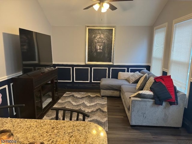 living room with ceiling fan, dark hardwood / wood-style floors, and lofted ceiling