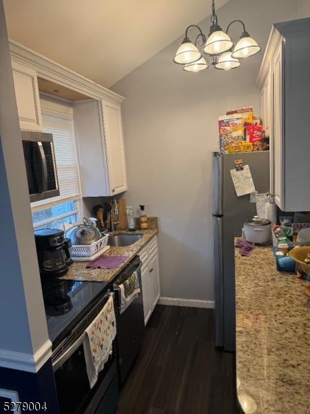 kitchen featuring decorative light fixtures, dishwasher, sink, range with electric stovetop, and white cabinets