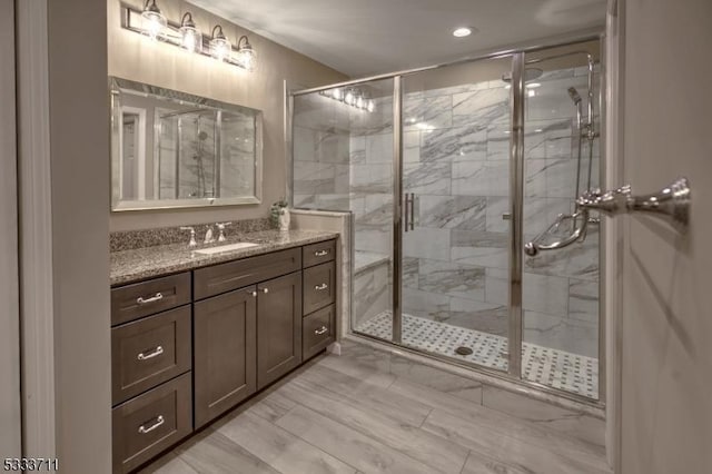 bathroom with vanity and a shower with shower door