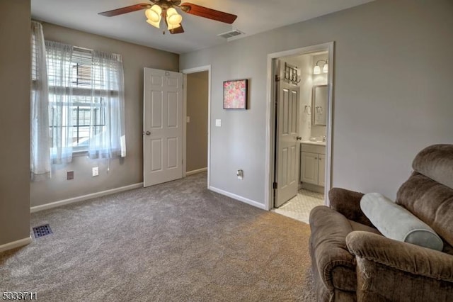 living area featuring ceiling fan and light carpet