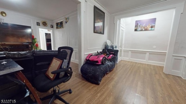 office space featuring crown molding and light hardwood / wood-style floors