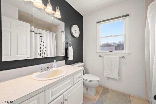 full bath with baseboards, a shower with shower curtain, toilet, tile patterned flooring, and vanity