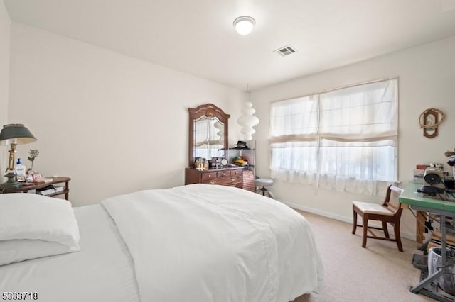 bedroom featuring light colored carpet, visible vents, and baseboards