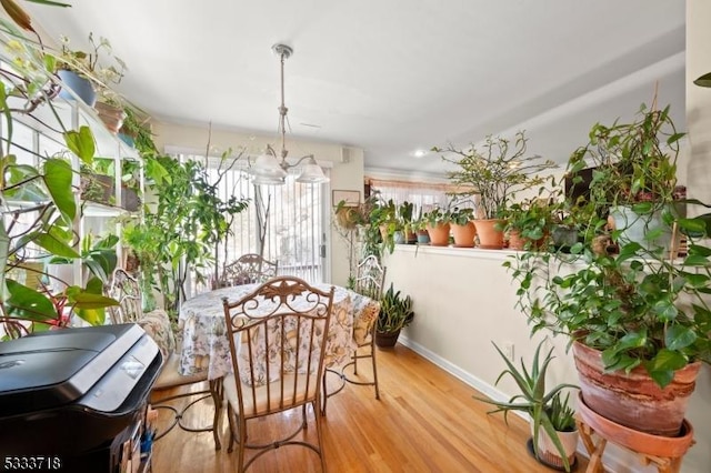 dining area with light wood-style floors and baseboards