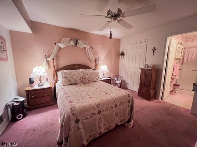 carpeted bedroom featuring ceiling fan and ensuite bathroom