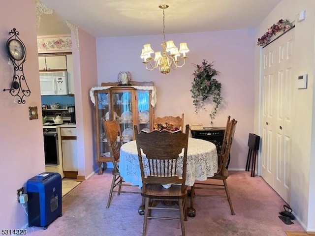 dining room with an inviting chandelier and light colored carpet