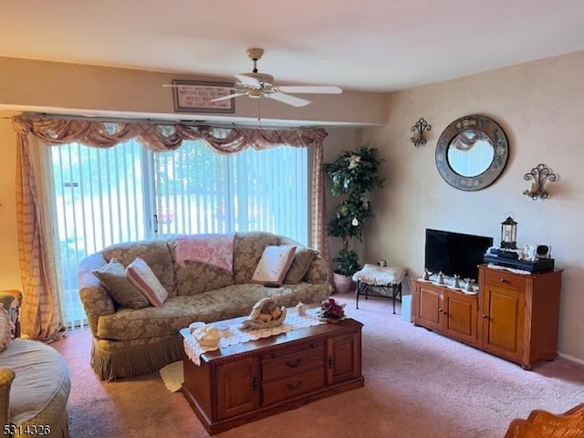 carpeted living room with ceiling fan