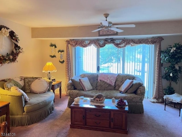 living room featuring carpet and ceiling fan