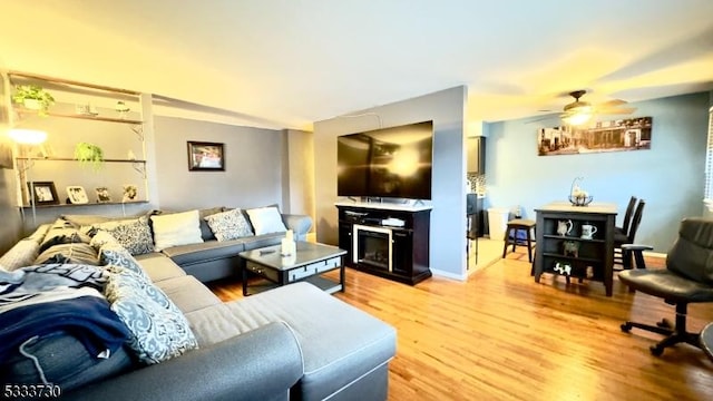 living room with ceiling fan and hardwood / wood-style floors