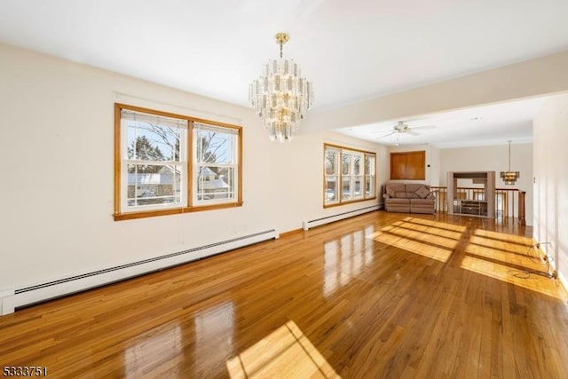 interior space with a notable chandelier, a baseboard radiator, and hardwood / wood-style floors