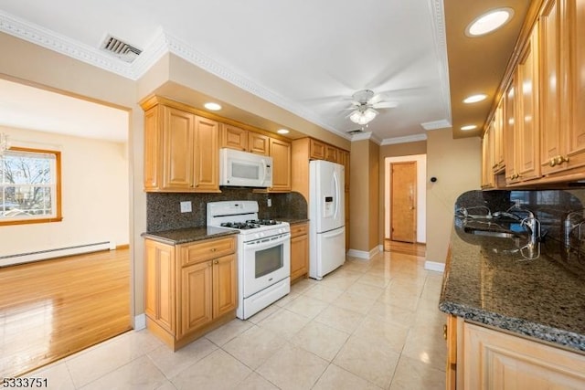 kitchen featuring dark stone countertops, white appliances, crown molding, and ceiling fan