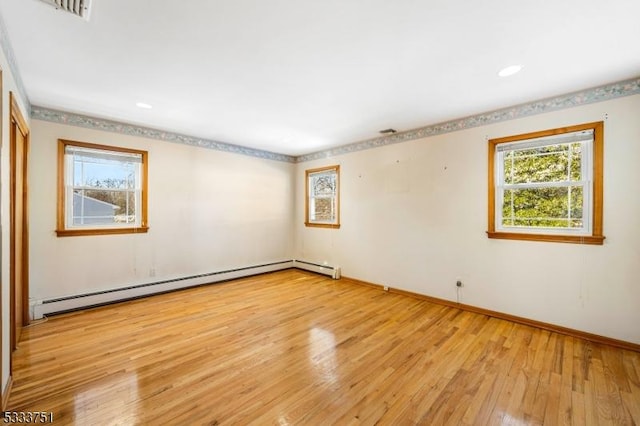 empty room with light hardwood / wood-style flooring and a baseboard radiator