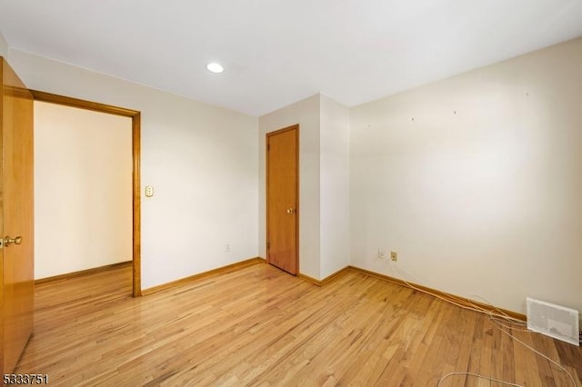 spare room with light hardwood / wood-style flooring