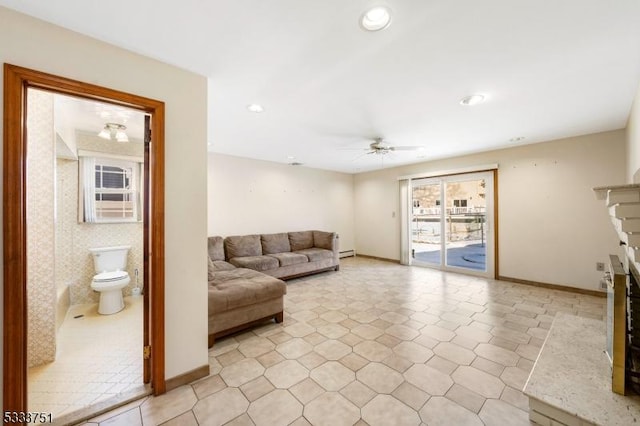 living room featuring a baseboard radiator and ceiling fan