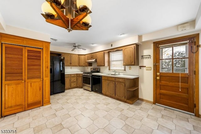 kitchen featuring sink, black appliances, and ceiling fan