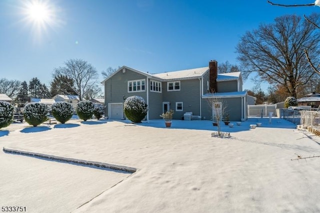 rear view of property with a garage