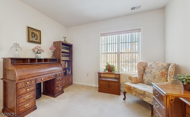 living area featuring light carpet