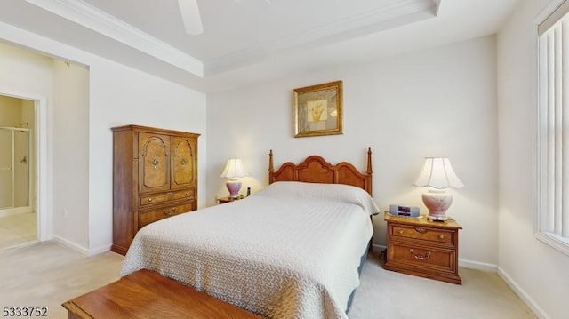 carpeted bedroom featuring ceiling fan, ornamental molding, and a tray ceiling