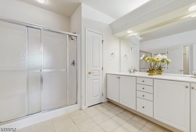 bathroom featuring tile patterned flooring, vanity, and walk in shower