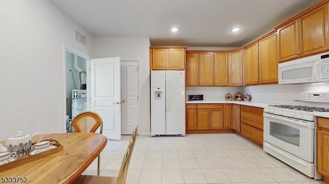 kitchen featuring white appliances and water heater