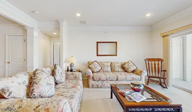 living room featuring decorative columns, crown molding, and light colored carpet