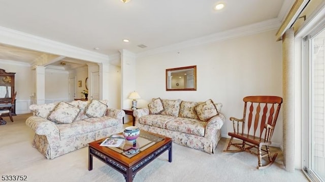 carpeted living room featuring crown molding and decorative columns