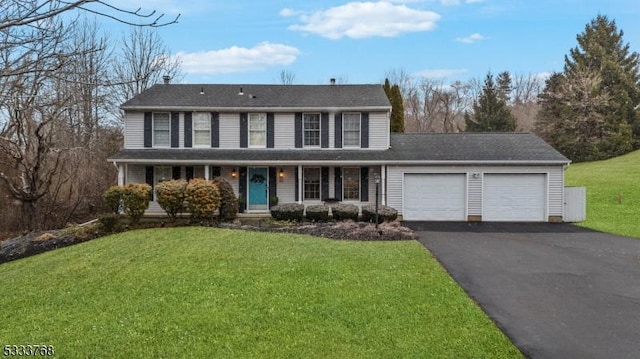 view of front of property featuring a garage and a front lawn