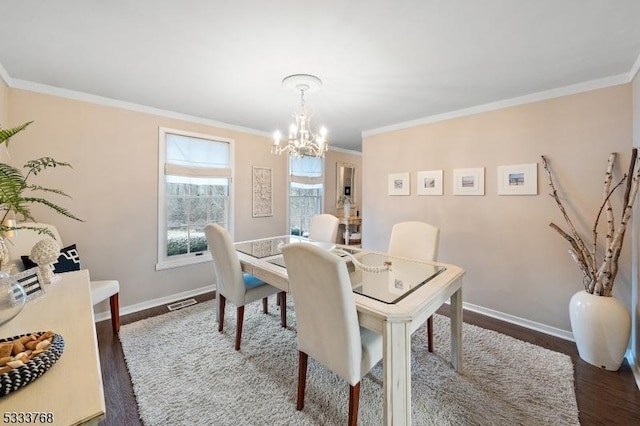 dining area featuring a chandelier, dark hardwood / wood-style floors, and ornamental molding