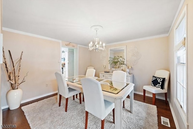 dining room featuring a notable chandelier, crown molding, and dark hardwood / wood-style floors