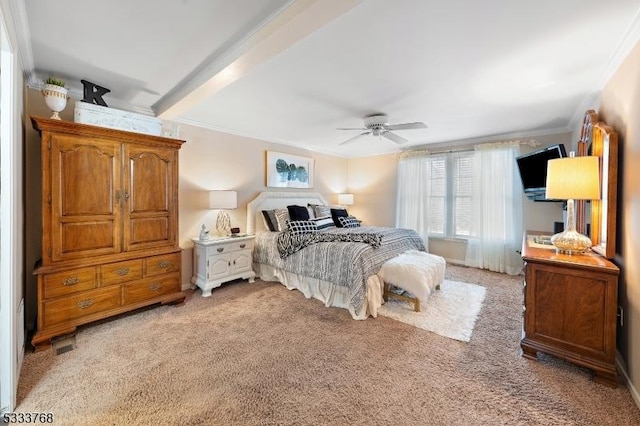 carpeted bedroom with ceiling fan, beamed ceiling, and ornamental molding