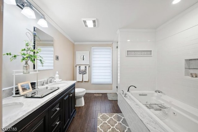 bathroom with wood-type flooring, tiled tub, toilet, vanity, and ornamental molding