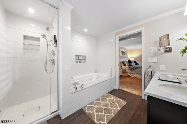 bathroom featuring hardwood / wood-style floors, vanity, ornamental molding, and separate shower and tub