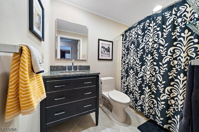 bathroom featuring toilet, vanity, ornamental molding, and tile patterned flooring